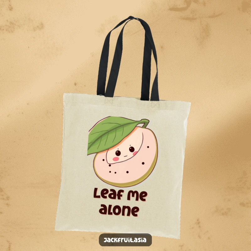 Funny tote bag featuring a shy jackfruit peeking from behind a leaf, adorned with giggling eye dots, a charming and humorous accessory.